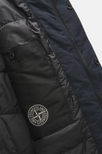 Close-up inside view of Stone Island Short Coat 'Micro Reps' navy, showing high-quality microfiber, smooth touch, wind and water repellent fabric, warm Primaloft filling, slim fit, two-way zipper, wind flap with buttons, turn-down collar, raglan sleeves, 
