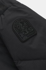 Close-up front-side view of the rubberized PARAJUMPERS label on the upper arm of the Parajumpers Down Parka 'Bearberry' navy, made of durable microfiber with warm down filling, wind- and water-repellent fabric, featuring regular fit, robust two-way zipper