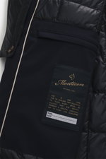 Close-up front detail of Montecore Down short coat dark navy showing pocket, quilted lining, and branded label, photographed from above.

<p>This exclusive short coat from MONTECORE with removable double front and warming down filling stylishly accompanie