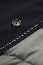 Close-up view of the Montecore Down Short Coat navy showing a branded button on high-quality microfiber fabric, a durable two-way zipper, and quilted lining fabric. This noble winter essential impresses with warming comfort and an elegant silhouette, feat