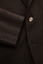 Close-up front view of the Brunello Cucinelli Suit black/brown checked showing fine glen check pattern, buttons, and wool-cashmere-silk fabric texture.