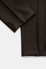 Close-up top-down view of the sleeve and bottom hem of the Brunello Cucinelli Suit black/brown checked, showing fine glen check fabric in wool, cashmere, and silk blend with a soft feel.  

<p>This suit by BRUNELLO CUCINELLI is what happens when Italian