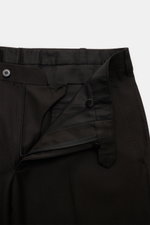 Dark navy Cesare Attolini Anzug pants shown from a close-up top-front view with open zipper and button closure, crafted from pure Super 150'S wool, slim fit, featuring French pockets and buttoned back pockets.