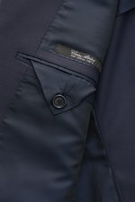 Close-up inside view of the Cesare Attolini Suit navy, showing the finely stitched lining, button detail, and label of pure Super 150'S wool.