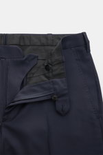 Close-up front view of the navy trousers from the Cesare Attolini Suit navy, made of pure Super 150'S wool with zip and button closure, French pockets, and a tapered cut, showcasing Neapolitan tailoring perfection. The smart-casual suit features supple fa