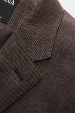 Zegna Anzug 'Natural' dunkelbraun meliert in Nahaufnahme, schmal geschnittenes Sakko mit markanter Webstruktur und fallendem Revers.