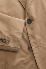 Santaniello Suit taupe close-up from above shows soft cotton twill fabric, buttons, step lapel, and fine stitching details.