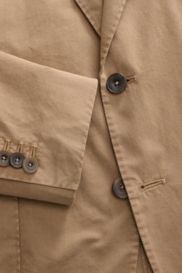 Santaniello Suit taupe close-up from above shows soft cotton twill fabric, buttons, step lapel, and fine stitching details.