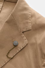 Close-up front angle of Santaniello Suit taupe lapel and button, showcasing pure cotton twill fabric and soft feel.