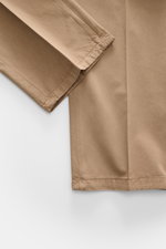 Close-up of Santaniello Suit taupe cotton twill sleeve and side seam from above, highlighting soft fabric and fine stitching details.