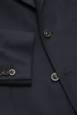 Close-up front view of the Boglioli Suit 'K. Jacket' navy showing tailored two-button jacket, notched lapel, patch hip pockets, tonal herringbone pure virgin wool fabric.