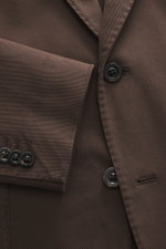Close-up view of the Boglioli Blazer 'K. Jacket' grey brown showing the fabric texture and buttons, made of stretch cotton twill, slim fit, two-button style, notched lapel, classic breast pocket, patch hip pockets, kissing buttons, rear side vents, uncons