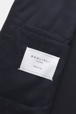 Close-up view of the dark navy Boglioli Suit 'K. Jacket' showing the tailored twill fabric, classic breast pocket, and Boglioli Milano label.