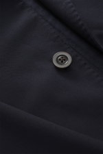 Close-up front view of the dark navy fabric and button of the Boglioli Suit 'K. Jacket', showcasing lightweight virgin wool twill.