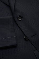 Close-up front view of the Tom Ford Anzug 'Shelton' navy/schwarz kariert showing fine woven wool fabric, slim-fit jacket with notch lapel, flap pockets, and black buttons.

<p>An Klasse und Zeitlosigkeit kaum zu übertreffen ist der luxuriöse TOM FORD Anzu