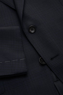 Close-up front view of the Tom Ford Anzug 'Shelton' navy/schwarz kariert showing fine woven wool fabric, slim-fit jacket with notch lapel, flap pockets, and black buttons.

<p>An Klasse und Zeitlosigkeit kaum zu übertreffen ist der luxuriöse TOM FORD Anzu