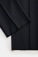 Close-up front view of Tom Ford Anzug 'Shelton' navy/schwarz kariert fabric showcasing luxury, pure wool, slim fit, Glencheck pattern, and fine weave texture.