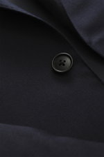 Close-up view of Belvest Suit navy button and lapel, made of pure super 150's wool with soft feel, slim fit; jacket features tailored two-button style, notched lapel with pin, breast and hip flap pockets, unfinished sleeve cuffs, rear vents, smooth lining