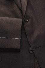 Close-up front view of Belvest Suit grey brown melange made from pure super 150'S wool with soft feel and slim fit, showing tailored two-button jacket, notched lapel with pin, classic breast pocket, hip pockets with flap, unfinished sleeve cuffs, and smoo