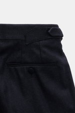 Close-up rear view of Stile Latino Suit 'Andrea' navy melange trouser waistband with side adjuster, button fly, and back pocket detail.