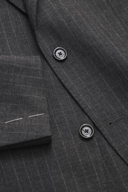 Close-up top-down view of the Lardini Anthracite striped suit jacket showing its pure new wool fabric, subtle check pattern, tailored two-button style, notched lapel with floral pin, classic breast pocket, patch hip pockets, and unfinished sleeve cuffs wi