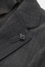 Close-up angled view of the Lardini Anthracite striped suit's lapel made of pure new wool with subtle check pattern, featuring a floral pin.