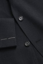 Close-up front view of the Lardini Suit dark navy melange showing pure new wool fabric with subtle check pattern, buttons, and tailored details.