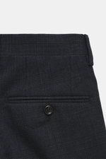 Close-up front view of Lardini Suit dark navy melange trousers showcasing pure new wool fabric with subtle check pattern, single pleat, and button details.