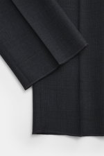 Close-up fabric detail of the Lardini Suit dark navy melange, showing subtle check pattern and fine wool texture from a top-down perspective.