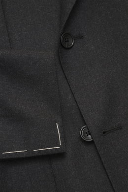 Close-up view of the Tagliatore Suit 'Vesuvio' anthracite melange showing the double-breasted three-button jacket with notched lapel, classic breast pocket, patch hip pockets, unfinished sleeve cuffs, and fine stitching detail, photographed from the front