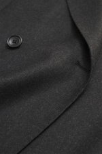 Close-up front view of Tagliatore Suit 'Vesuvio' anthracite melange showing the soft virgin wool and cashmere blend fabric, double-breasted three-button jacket with notched lapel, patch hip pockets, and precise tailoring.