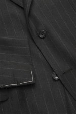 Close-up front view of the Tagliatore Suit 'Vesuvio' anthracite striped jacket made from pure Super 110's virgin wool with chalk stripes, tailored two-button style, notched lapel, and classic breast pocket.