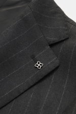 Close-up angled view of Tagliatore Suit 'Vesuvio' anthracite striped lapel showing classic chalk stripes, Super 110's wool, and a silver pin.