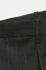 Close-up front view of the waistband of the Tagliatore Suit 'Vesuvio' anthracite striped trousers in pure Super 110's virgin wool with classic chalk stripes, showing soft touch fabric and detailed stitching. Elegant silhouette meets Italian tradition: The