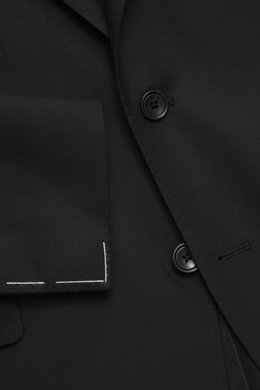 Close-up front view of the Tagliatore Suit 'Vesuvio' black jacket showing soft Super 120's virgin wool fabric, two-button style, notched lapel with pin, and classic breast pocket with precise tailoring.