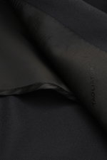 Close-up shot of the inside lining and fabric texture of the Tagliatore Suit 'Vesuvio' black, made of pure Super 120's virgin wool, showcasing Italian craftsmanship and soft touch.