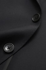 Close-up front view of the Tagliatore Suit 'Vesuvio' black showcasing its two-button, notched lapel jacket made from soft Super 120's virgin wool.