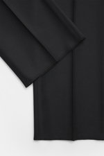 Close-up front view of Tagliatore Suit 'Vesuvio' black fabric showing smooth, pure Super 120's virgin wool in slim fit style.