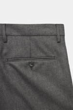 Close-up rear view of the Tagliatore Suit 'Vesuvio' grey melange trousers, made of Super 110's virgin wool with slight stretch, featuring a buttoned back pocket and belt loops.