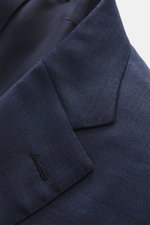 Close-up angled view of the Brioni Suit 'Brunico' navy melange jacket lapel and buttonhole, showing fine pure wool fabric with smooth touch and slim fit elegance.