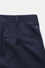 Close-up rear view of the Brioni Suit 'Brunico' navy melange trousers, made from pure wool with a smooth touch and slim fit, showing waistband, belt loop, button, and French pocket details.
