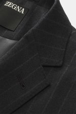Close-up front angle of Zegna Suit dark grey striped collar and lapel showing elastic wool fabric with soft feel and classic pinstripe pattern.