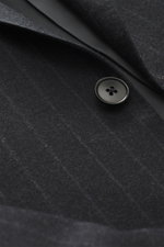 Close-up front view of the Zegna Suit dark grey striped button and fabric showcasing elastic wool, slim fit, and classic pinstripe pattern.