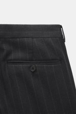 Close-up rear view of Zegna Suit dark grey striped trousers showcasing elastic wool, soft feel, classic pinstripe, slightly tapered fit, and buttoned back pocket.