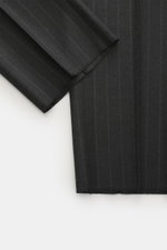Close-up view of the Zegna Suit dark grey striped fabric showing elastic wool with a soft feel and classic pinstripe pattern.