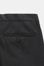 Close-up rear view of the black Zegna Anzug 'Milano Trofeo' pants showing pure wool fabric with soft touch, slim fit, buttoned back pocket, and belt loop.