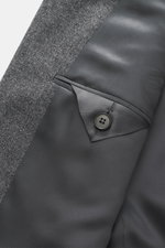 Close-up interior view of Zegna Suit grey melange showcasing pure wool fabric, soft touch, distinctive woven texture, and tailored pocket details.