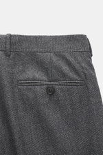 Back view close-up of the Zegna Suit grey melange trousers, showing pure wool fabric with a soft touch, slim fit, buttoned back pocket, and distinctive woven texture.