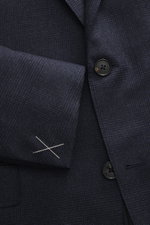 Close-up front view of Zegna Suit 'Trofeo' navy melange showcasing its subtle check pattern, pure wool fabric, and tailored two-button jacket with notched lapel and soft touch.