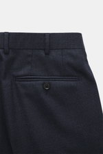 Close-up front view of the waistband and back pocket of the Zegna Suit 'Trofeo' navy melange trousers, featuring a subtle check pattern, pure wool, soft touch, and slim fit.